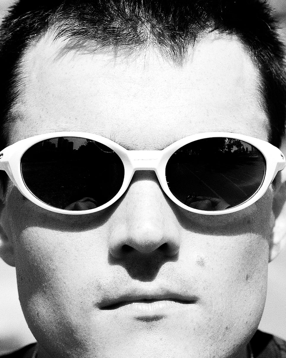 Black and white close-up of a person wearing sunglasses.